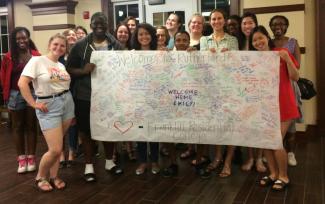 Students holding welcome sign in Rutherford