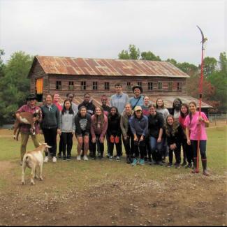 FRC members take group picture in front of Sweet Olive Farm