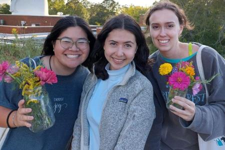 3 FRC members with harvested Zinnia flowers